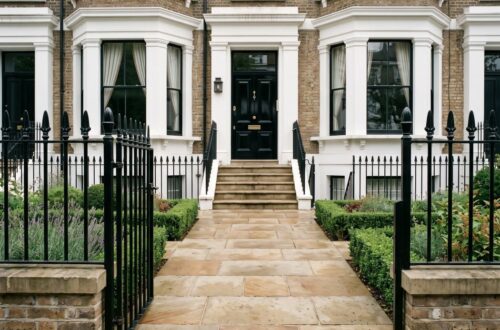 the front approach to a large, elegant West London Victorian townhouse with a York stone-paved frontway leading directly to the main entrance