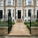 the front approach to a large, elegant West London Victorian townhouse with a York stone-paved frontway leading directly to the main entrance